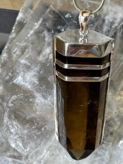 This is a smokey quartz pendant set in 925 silver. It is a powerful protector and healer. grounding you and feeling connected. thecrystalcave.com.au