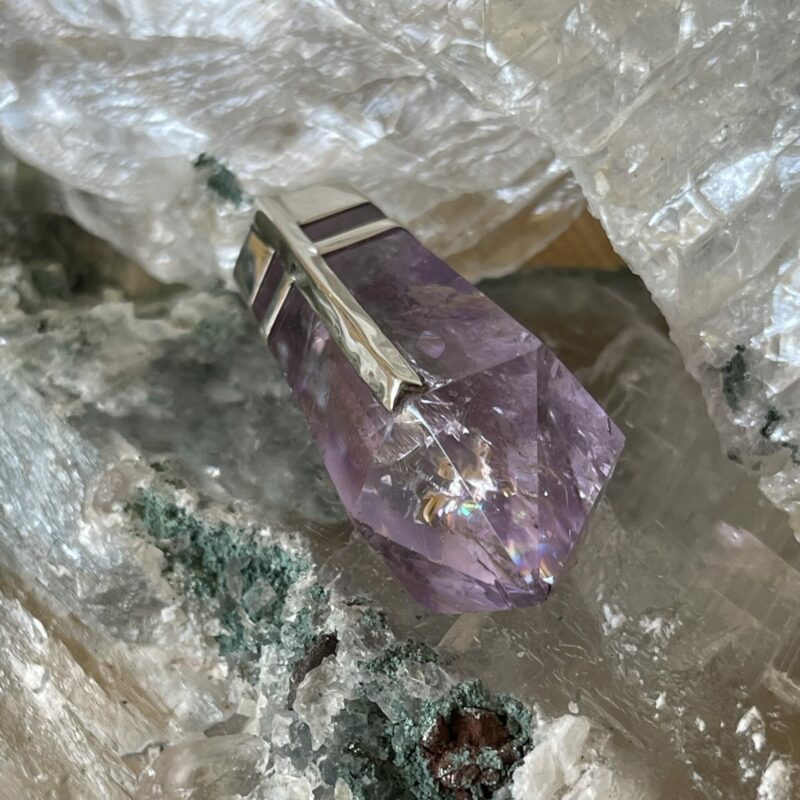This is an Amethyst pendant. It has deep clear colour and is particularly beautiful. set in stirling silver. It is both protective and connective. thecrystalcave.com.auThis is an Amethyst pendant. It has deep clear colour and is particularly beautiful. set in stirling silver. It is both protective and connective. thecrystalcave.com.au
