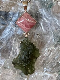 This is a stunning Moldavite and Rhodochrosite pendant hand crafted and set in stirling silver. thecrystalcave.com.au