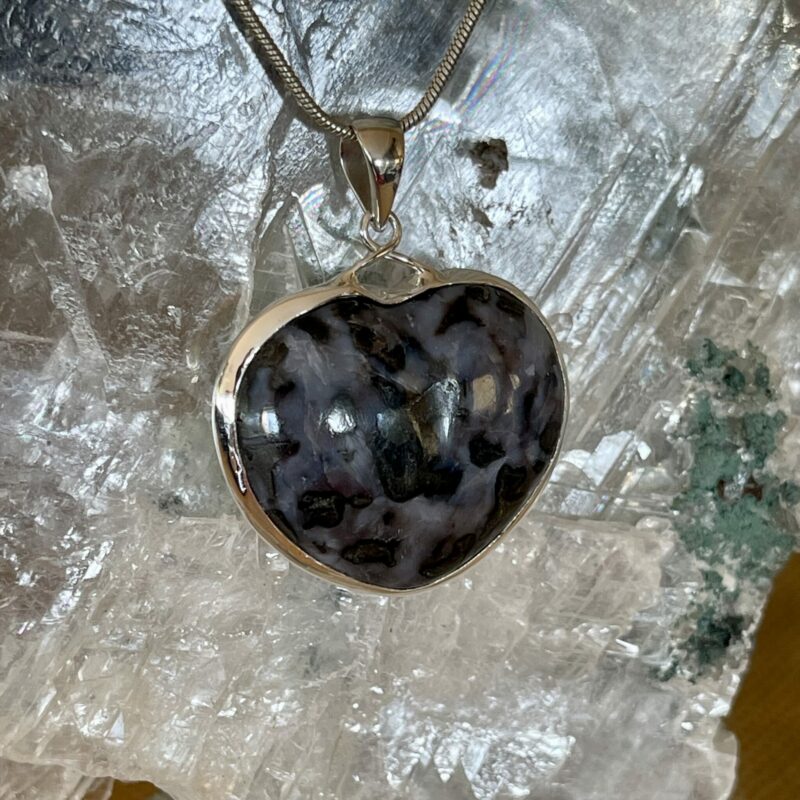 This is a Mystic Merlinite heart set in 927 silver pendant. Its energy opens the doorways of magic and ritual. Favoured for centuries by Druids and Shaman alike, its protective energies are revered, as it deflects negative energies.  thecrystalcave.com.au