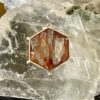 This is a highly polished Hematoid stone. Shaped as a merkabah and set in stirling siler it is truly beautiful. thecrystalcave.com.au