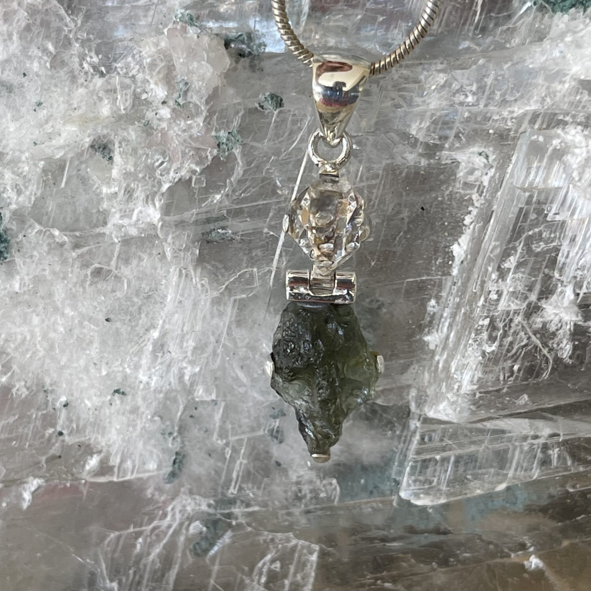 This is a Moldavite and herkimer pendant, set in 925 Stirling silver. thecrystalcave.com.au