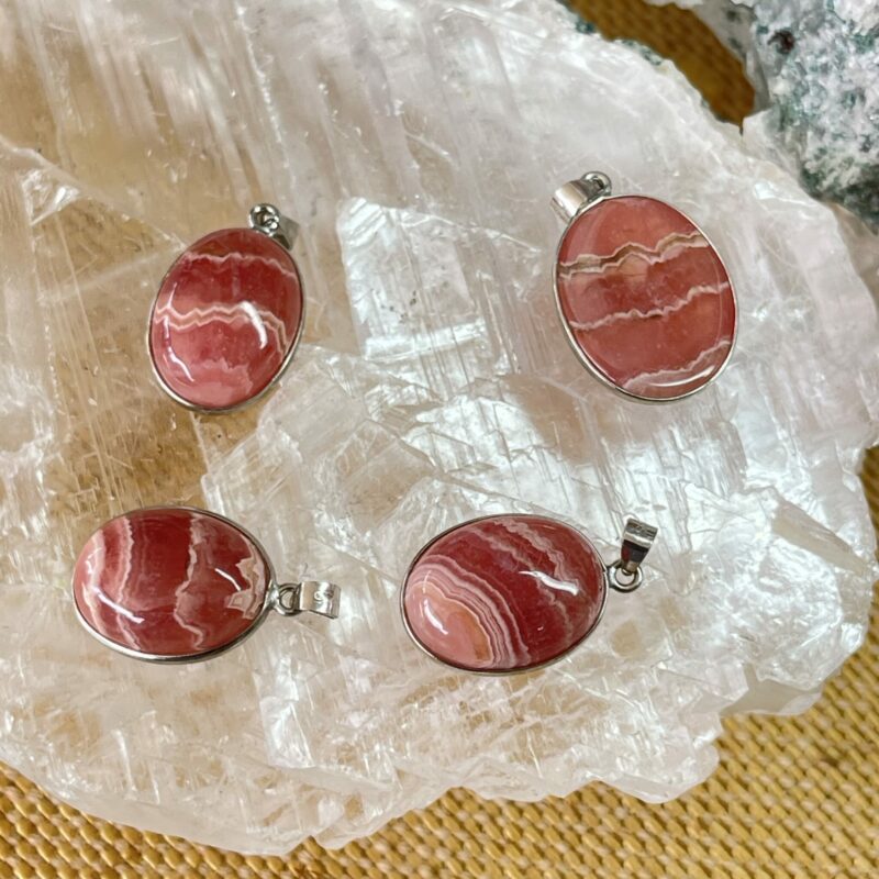 This is a selection of Rhodochrosite oval cut cabochons set in 925 stirling silver. thecrystalcave.com.au