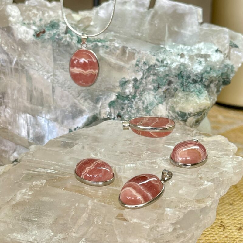 This is a selection of Rhodochrosite oval cut cabochons set in 925 stirling silver. thecrystalcave.com.au