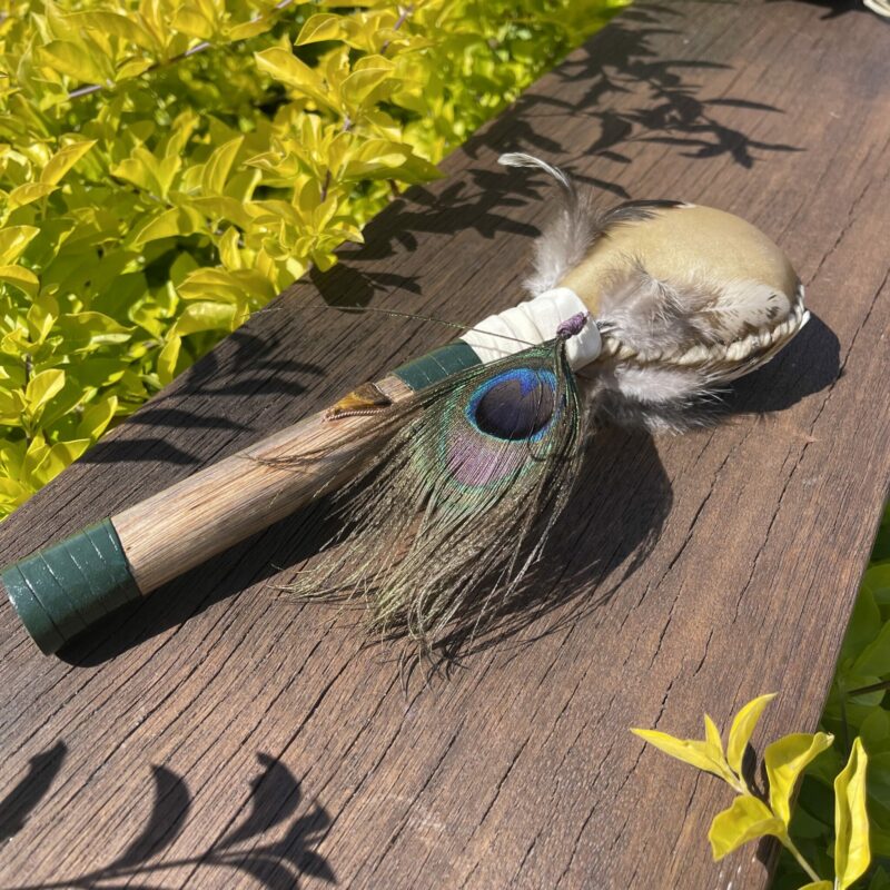 This is Shamanic rattle with Peacock Feather and Tiger Eye Crystal