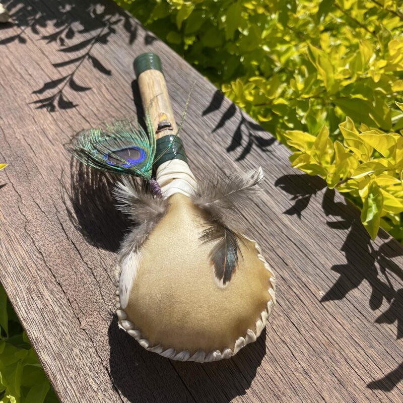 This is Shamanic rattle with Peacock Feather and Tiger Eye Crystal