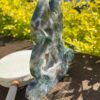 This is Moss Agate Geode Cat Carving – A Touch of Nature’s Magic