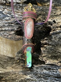 This is Talisman of Elevated Passion with titanium aura point, rose quartz and brass merkabah