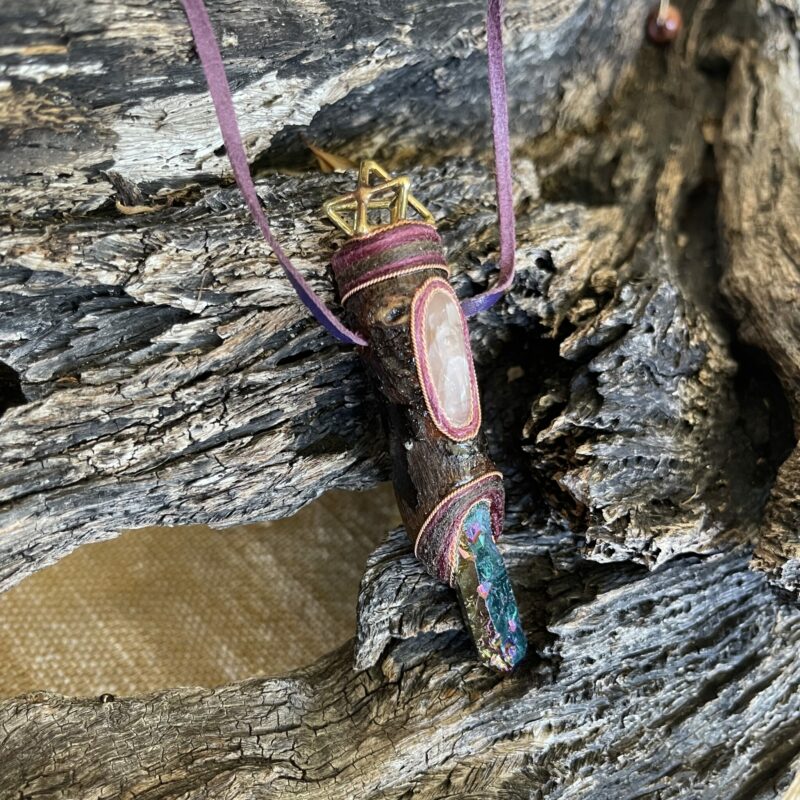 This is Talisman of Elevated Passion with titanium aura point, rose quartz and brass merkabah