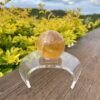 This is Mesmerizing Honey Calcite Sphere 62mm