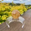 This is Mesmerizing Honey Calcite Sphere 62mm