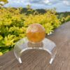 This is Mesmerizing Honey Calcite Sphere 62mm