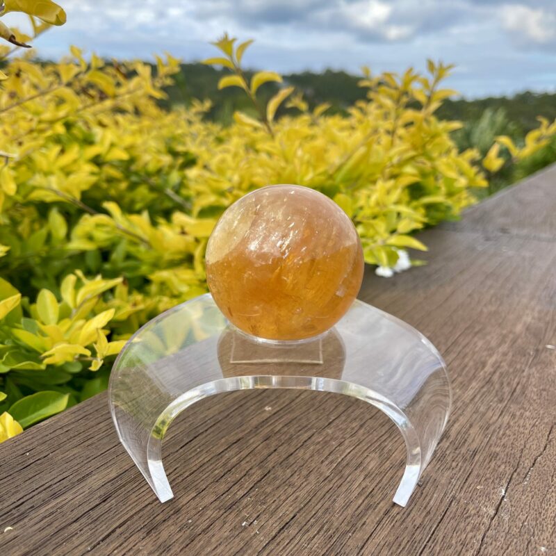 This is Mesmerizing Honey Calcite Sphere 62mm