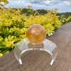 This is Mesmerizing Honey Calcite Sphere 62mm