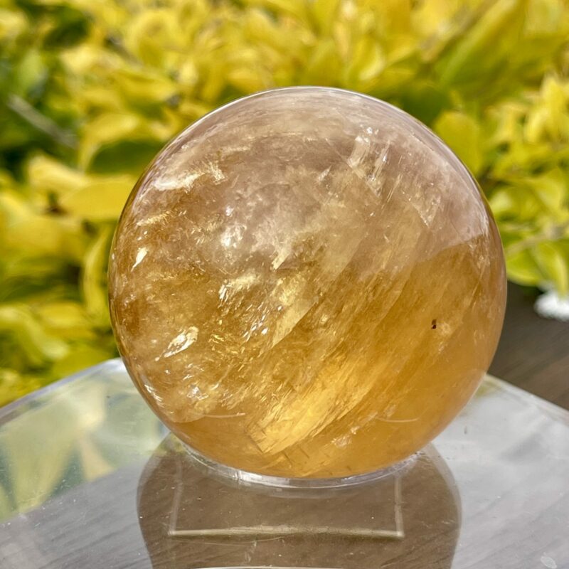 This is Mesmerizing Honey Calcite Sphere 62mm