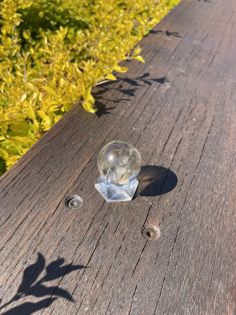 This is Rainbow-Filled Light Smoky Quartz Sphere 4cm