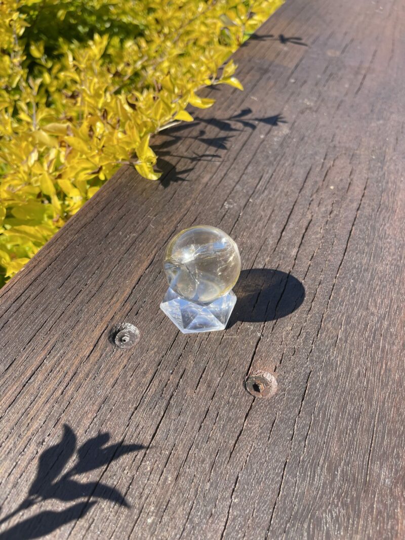 This is Rainbow-Filled Light Smoky Quartz Sphere 4cm