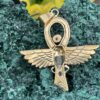 This is Brass Ankh with Wings of Isis, Scarab, Abalone Accents, and Clear Quartz