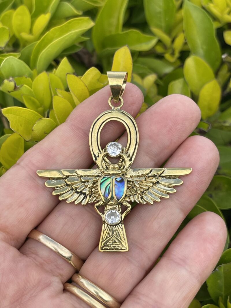 This is Brass Ankh with Wings of Isis, Scarab, Abalone Accents, and Clear Quartz