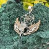 This is Brass and Silver Hypercube Raven Skull Wing Pendant