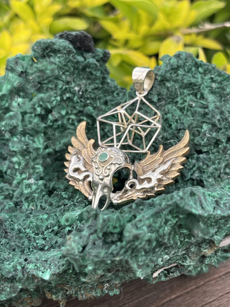 This is Brass and Silver Hypercube Raven Skull Wing Pendant