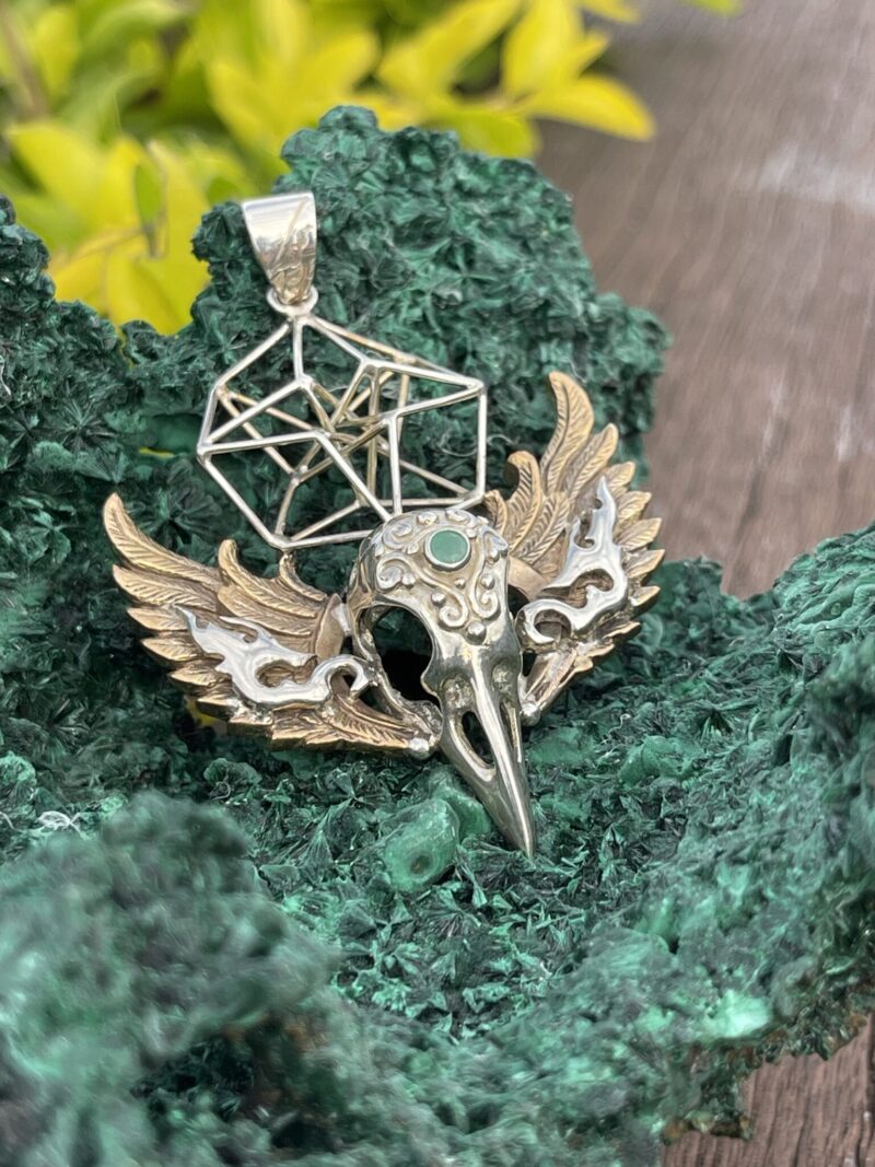 This is Brass and Silver Hypercube Raven Skull Wing Pendant