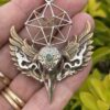 This is Brass and Silver Hypercube Raven Skull Wing Pendant