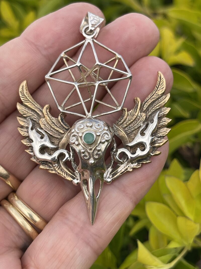 This is Brass and Silver Hypercube Raven Skull Wing Pendant