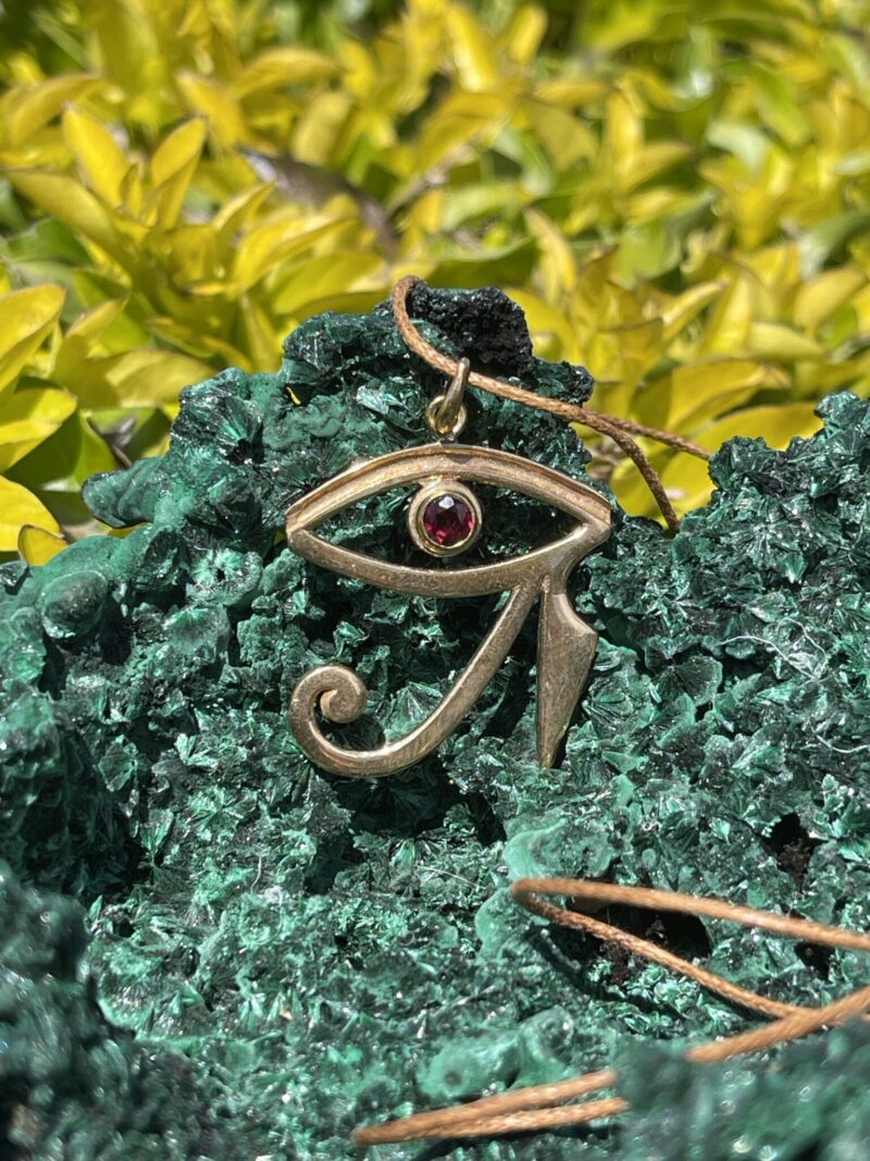 This is stunning Brass Eye of Horus Pendant with Garnet Eye