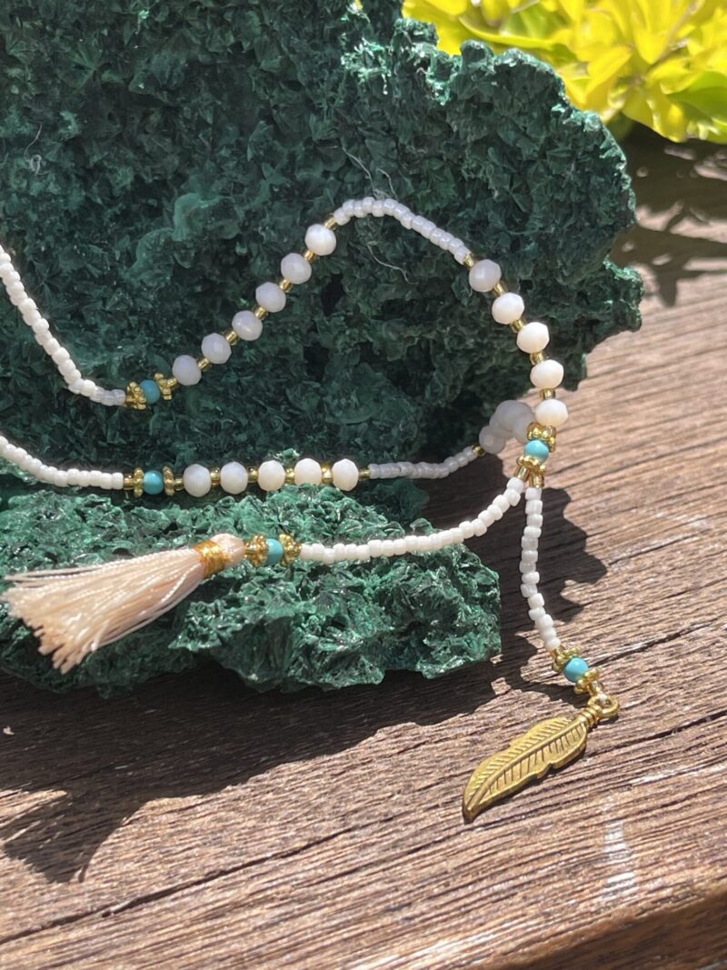 This is White and Cream Bead Ohm Feather Necklace