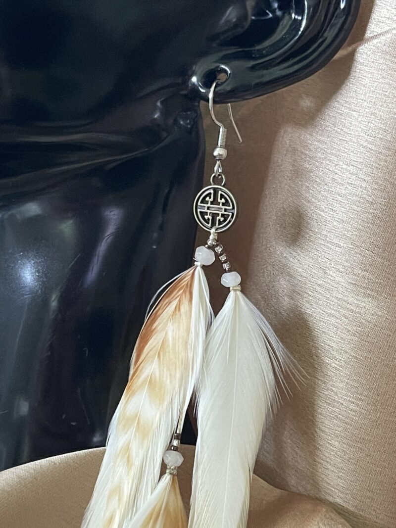 These are Lucky Coin Cream Feather Earrings – Timeless Elegance with a Touch of Luck