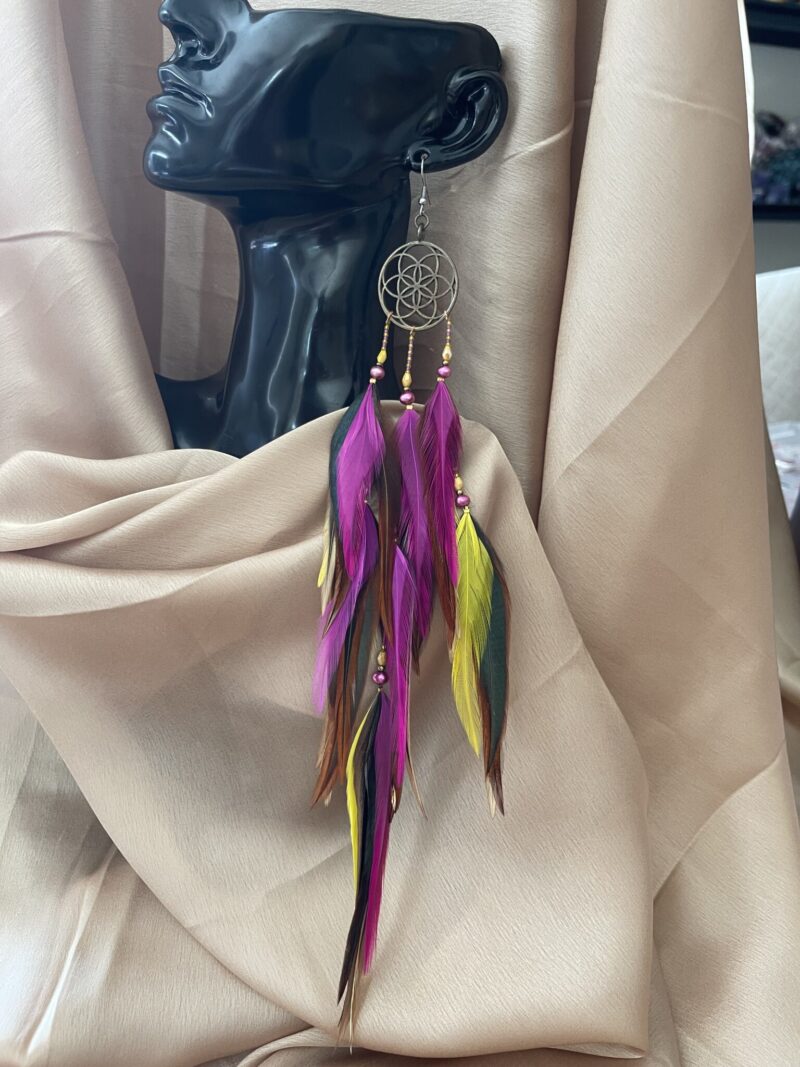 these are Featuring hot pink, yellow, brown, and black feathers paired with pink and gold