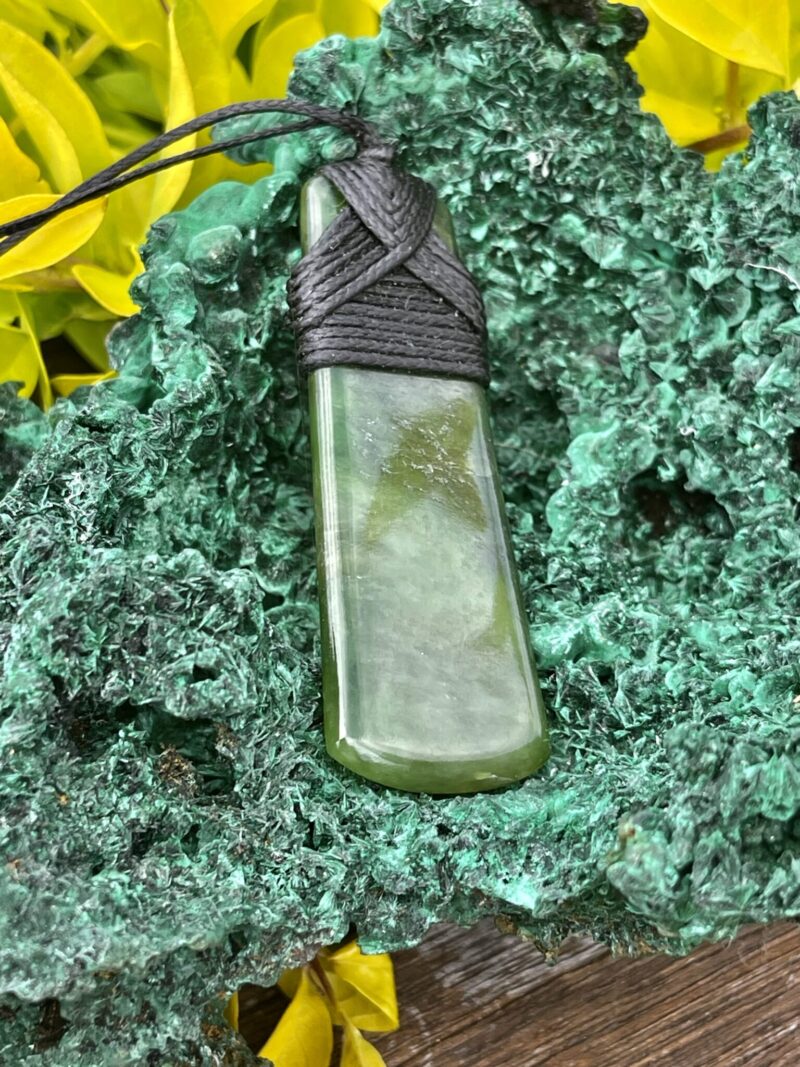 This is Elegant New Zealand Greenstone Pounamu Necklace with Black Cord – 7 x 2.5 cm