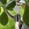 This is Lunar Glow: Moldavite Rainbow Moonstone Pendant in Silver M557